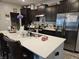 Kitchen featuring a large island, stainless steel appliances, and dark cabinetry at 1439 Silver Pine Ln, Sheridan, IN 46069