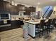 Spacious kitchen featuring dark cabinetry, stainless steel appliances, and a central island with seating at 1439 Silver Pine Ln, Sheridan, IN 46069