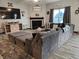 Spacious living room featuring a comfortable sectional sofa, decorative accents, and a view of the fireplace at 1439 Silver Pine Ln, Sheridan, IN 46069