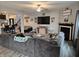 Bright living room with a large sectional, centered around a fireplace and entertainment area, ideal for gatherings at 1439 Silver Pine Ln, Sheridan, IN 46069