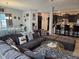 Inviting living room with comfortable seating, a large sofa, and a view into the modern kitchen at 1439 Silver Pine Ln, Sheridan, IN 46069