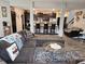 Open-concept living room showcases a large sectional sofa, decorative rug, and seamless transition to the kitchen area at 1439 Silver Pine Ln, Sheridan, IN 46069