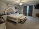 Relaxing bedroom features soft carpeting, a ceiling fan, and a window with gray curtains at 1439 Silver Pine Ln, Sheridan, IN 46069
