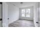 Well-lit bedroom with neutral walls, wood floors, and large windows facing neighborhood at 15946 Meadow Frost Ct, Fishers, IN 46037