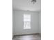 Bright bedroom featuring modern gray flooring and a large window at 15946 Meadow Frost Ct, Fishers, IN 46037