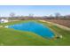 Beautiful aerial view of the community pond, surrounded by pristine landscaping and grassy areas at 15946 Meadow Frost Ct, Fishers, IN 46037