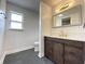 Bright bathroom with modern vanity, dark wood cabinets, elegant fixtures, and stylish tile flooring at 1649 N Arsenal Ave, Indianapolis, IN 46218