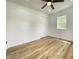 Well-lit bedroom with wood floors, closet and a window with a view at 1649 N Arsenal Ave, Indianapolis, IN 46218