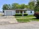 Charming single-story home with white siding, inviting entryway, and a well-manicured front yard at 1649 N Arsenal Ave, Indianapolis, IN 46218