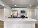 Modern kitchen with stainless steel appliances, white cabinets, island with sink, and stylish backsplash at 1649 N Arsenal Ave, Indianapolis, IN 46218