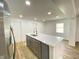 Modern kitchen featuring a center island with sink, stainless steel appliances, and ample natural light at 1649 N Arsenal Ave, Indianapolis, IN 46218
