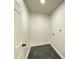 Clean, white laundry room with tile floor and hook ups at 1649 N Arsenal Ave, Indianapolis, IN 46218