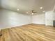 Spacious room features ceiling fan, hardwood floors, natural light, and neutral colors at 1649 N Arsenal Ave, Indianapolis, IN 46218