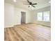 Bright living room with beautiful wood floors and a modern ceiling fan at 1649 N Arsenal Ave, Indianapolis, IN 46218