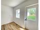 Mud room features modern flooring, bright light and access to the backyard at 1649 N Arsenal Ave, Indianapolis, IN 46218