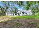 Rear of home with a detached garage, surrounded by a spacious lawn at 1805 Center Valley Rd, Martinsville, IN 46151