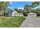 Charming two-story home with a gravel driveway and detached garage, set against a backdrop of lush greenery at 1805 Center Valley Rd, Martinsville, IN 46151
