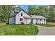Charming two-story home with freshly painted white brick, professional landscaping, and gravel driveway at 1805 Center Valley Rd, Martinsville, IN 46151
