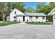 Charming two-story home with freshly painted white brick, professional landscaping, and gravel driveway at 1805 Center Valley Rd, Martinsville, IN 46151