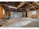 Spacious two-car garage interior showing overhead lighting and a black side door at 1805 Center Valley Rd, Martinsville, IN 46151
