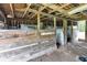 Barn interior featuring wooden beams, stall dividers, and aged wooden supports at 1805 Center Valley Rd, Martinsville, IN 46151