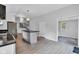 Eat-in kitchen featuring white cabinets, stainless appliances, center island, wood-look floors, and neutral walls at 1805 Center Valley Rd, Martinsville, IN 46151