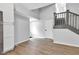 Spacious living room featuring light gray walls, wood-look floors, staircase, and neutral trim at 1805 Center Valley Rd, Martinsville, IN 46151