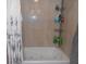 Close-up of bathtub and tile surround with toiletry organization at 2020 N Hickory Blvd, Greenfield, IN 46140