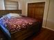 Bedroom featuring a wooden bed frame with a patterned duvet and a large closet at 2020 N Hickory Blvd, Greenfield, IN 46140