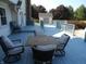 A wood table with cushioned chairs sits on the light-blue painted backyard deck at 2020 N Hickory Blvd, Greenfield, IN 46140