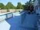 Spacious blue deck overlooking a refreshing in-ground pool and lush backyard at 2020 N Hickory Blvd, Greenfield, IN 46140
