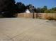 Spacious driveway with a basketball hoop, leading to a garage, and fenced backyard at 2020 N Hickory Blvd, Greenfield, IN 46140