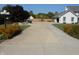 Long driveway leading to a home with a basketball hoop and attached garage at 2020 N Hickory Blvd, Greenfield, IN 46140
