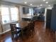 Open-concept kitchen featuring gray cabinets, stainless steel appliances, and a dining area with natural light at 2020 N Hickory Blvd, Greenfield, IN 46140