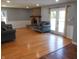 Bright living room with hardwood floors, a brick fireplace, and double doors to the outside at 2020 N Hickory Blvd, Greenfield, IN 46140