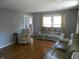 Bright living room features hardwood flooring and comfortable neutral-colored furniture at 2020 N Hickory Blvd, Greenfield, IN 46140