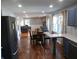 Open-concept living space with hardwood floors, fireplace, and an adjacent updated kitchen at 2020 N Hickory Blvd, Greenfield, IN 46140