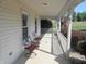 Relaxing covered porch with comfortable seating, perfect for enjoying the outdoor scenery at 2020 N Hickory Blvd, Greenfield, IN 46140