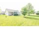 Large backyard with mature trees and a well-manicured lawn surrounding the property at 2402 Foxtail Dr, Plainfield, IN 46168