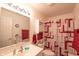 Bright bathroom features modern fixtures, a decorative shower curtain, and a mirrored vanity at 2402 Foxtail Dr, Plainfield, IN 46168