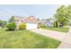 Well-maintained home featuring a large front yard and a long driveway for easy parking at 2402 Foxtail Dr, Plainfield, IN 46168