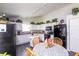 Charming kitchen boasts white cabinets, black appliances, and a cozy breakfast nook, perfect for Gathering meals at 2402 Foxtail Dr, Plainfield, IN 46168