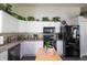 Well-maintained kitchen boasts white cabinets, black appliances, and an adjacent dining area at 2402 Foxtail Dr, Plainfield, IN 46168