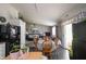 Cozy eat-in kitchen with modern appliances, an adjacent living room and a black refrigerator at 2402 Foxtail Dr, Plainfield, IN 46168