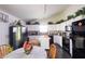 Bright eat-in kitchen features modern appliances, white cabinets, and an adjacent dining area at 2402 Foxtail Dr, Plainfield, IN 46168