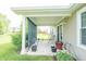 Relaxing covered patio with seating, plants, and a view of the backyard at 2402 Foxtail Dr, Plainfield, IN 46168