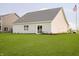 Spacious backyard with well-kept lawn, gray roof, and a patio sliding glass door at 278 Evening Bay Ct, Pendleton, IN 46064