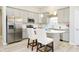 Bright kitchen features stainless steel appliances, quartz countertops, and eat-in island at 278 Evening Bay Ct, Pendleton, IN 46064