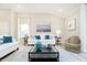 Open living room with a white sofa with blue accents and a stylish black metal coffee table at 278 Evening Bay Ct, Pendleton, IN 46064