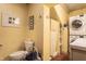 Clean bathroom with toilet and a stacked washer and dryer, all in a bright, inviting space at 3959 Central Ave, Indianapolis, IN 46205